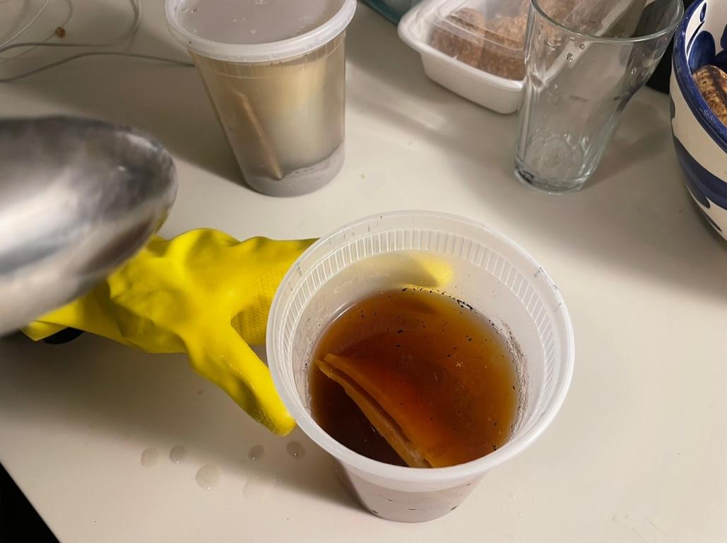 A hand in a yellow glove holding the horn