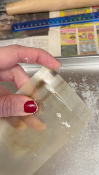 A hand holding a piece of horn