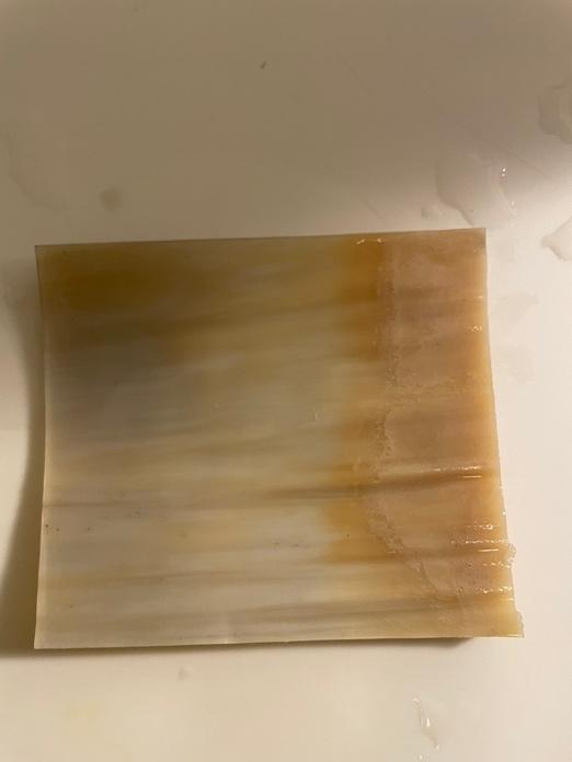 A piece of horn with a brown stain on it