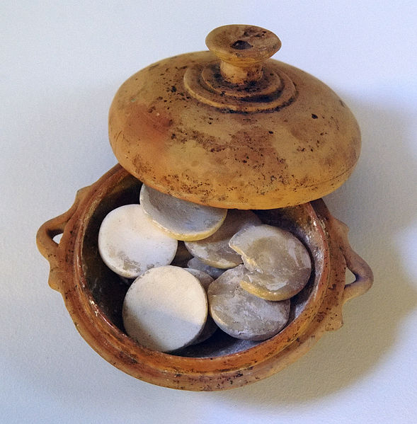 Ceramic pot filled with white pucks