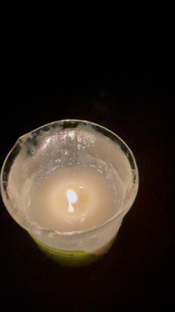 A candle in a glass Description automatically generated with medium confidence