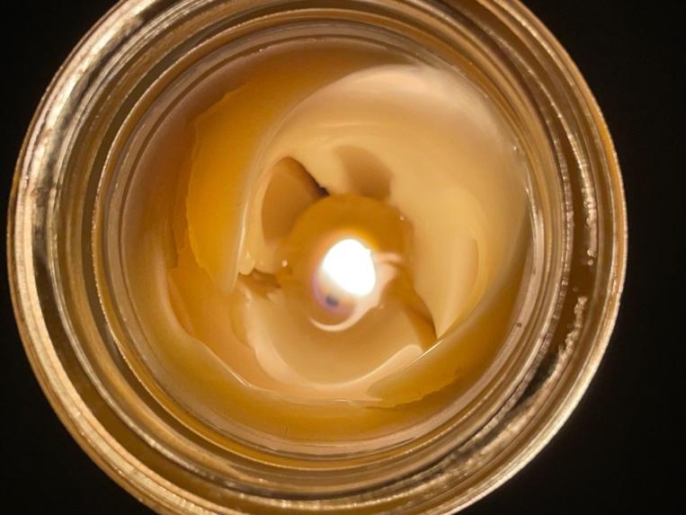 A candle in a jar Description automatically generated with low confidence